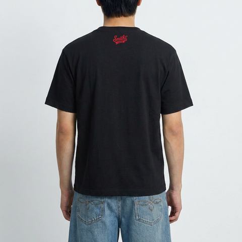 A male model wearing the Smith's 1906 MTE05B Black T-Shirt with Brooklyn Graphic is showing the back.