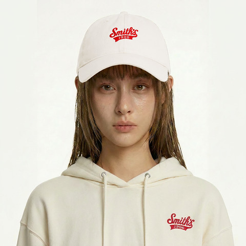 A female model wearing the Smith's 1906 UCP02 White Cap is showing the front.